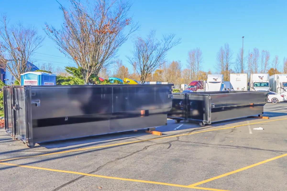 Professional dumpster rental service with roll-off container on residential driveway in Shively